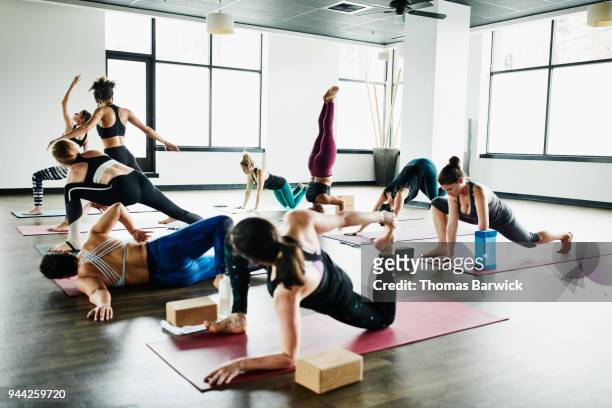 Women warming up for hot yoga class in fitness studio