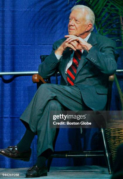 Former President Jimmy Carter sits on stages before he is introduced at the Gosman Center on the campus of Brandeis University in Waltham, Mass., on...