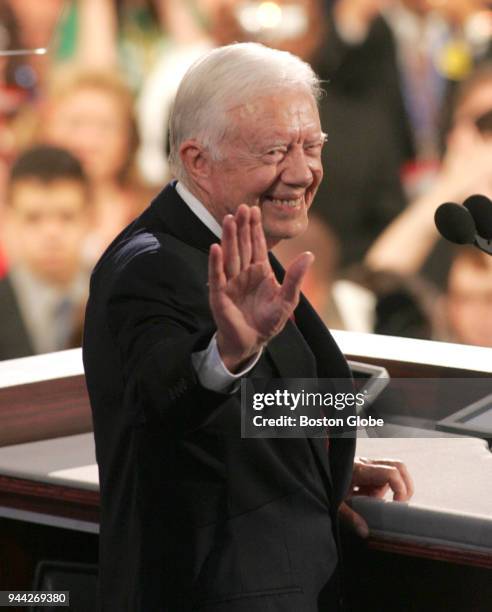 Former President Jimmy Carter waves to delegates at the Democratic National Convention at the FleetCenter in Boston on July 26, 2004.