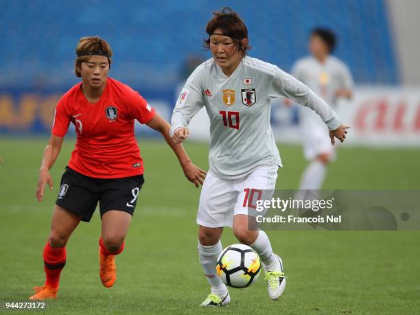 Mizuho Sakaguchi of Japan and Jeon Ga Eul of Korea in action during the AFC Women's Asian Cup Group B match between South Korea and Japan at the...
