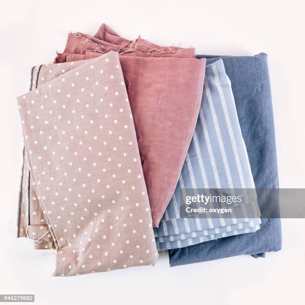 stack of fabrics over white - loja de miudezas imagens e fotografias de stock