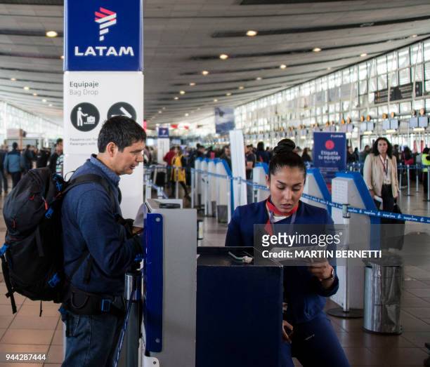 Passenger arrives at the Lan Express' check-in area at the departures terminal of Santiago's international airport, during an indefinite strike...