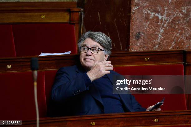 Front National Deputy Gilbert Collard react as Ministers answer deputies during the weekly session of questions to the government at Assemblee...