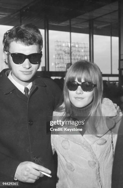 French singer and actor Johnny Hallyday with his wife Sylvie Vartan at Orly Airport in Paris, 3rd January 1967. They are en route to Tehran, on the...