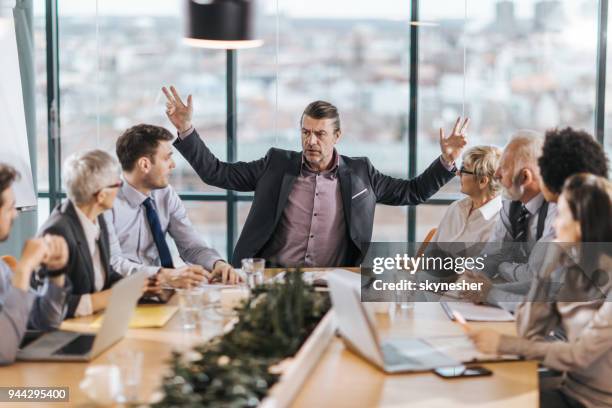 frustrated ceo is angry at his colleagues during a meeting in the office. - angery stock pictures, royalty-free photos & images