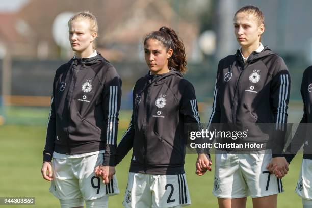 Anna-Lena Stolze, Fatma Sakar and Melissa Koessler of Germany line up during the national anthem prior to the UEFA Women's Under19 Elite Round match...