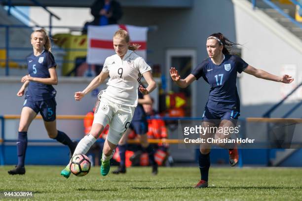 Anna-Lena Stolze of Germany challenges Georgia Eaton-Collins of England for the ball during the UEFA Women's Under19 Elite Round match between...