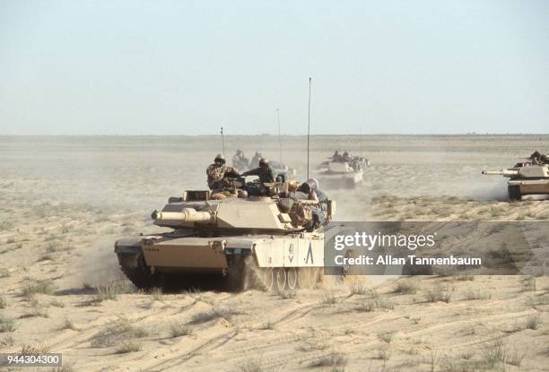 View of American M1A1 Abrams tanks as they cross the desert during the Gulf War, Iraq, 1991.