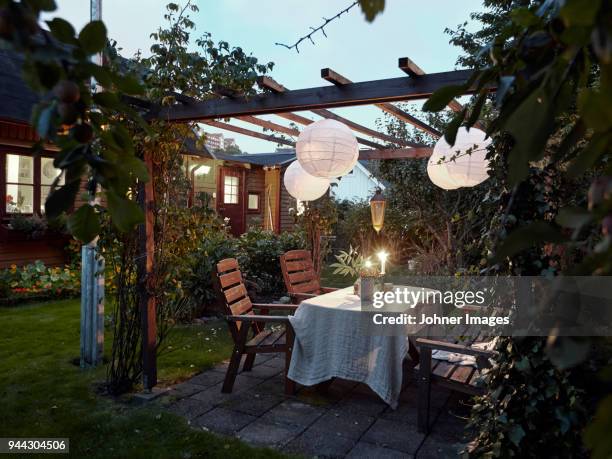 table set in garden - garden lighting stock pictures, royalty-free photos & images