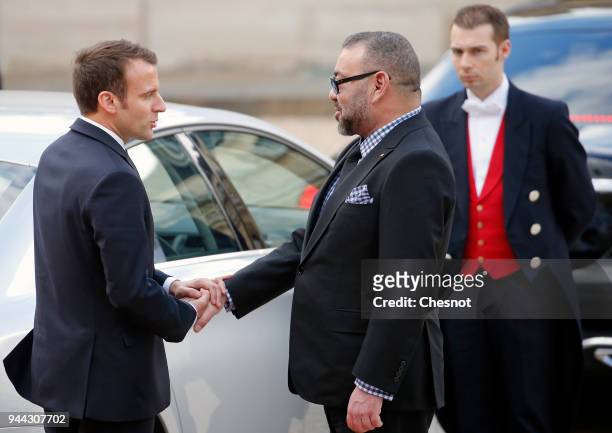 French President Emmanuel Macron accompanies Morocco's King Mohammed VI after their meeting at the Elysee Presidential Palace on April 10, 2018 in...