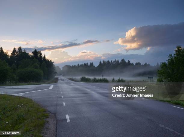 view of country road - road intersection stock-fotos und bilder