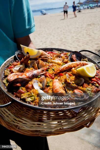 seafood paella on beach - paella stock-fotos und bilder