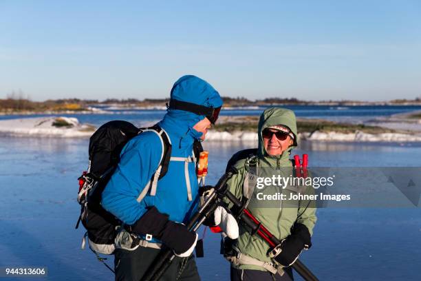 people long-distance skating on frozen lake - long distance relationship stockfoto's en -beelden