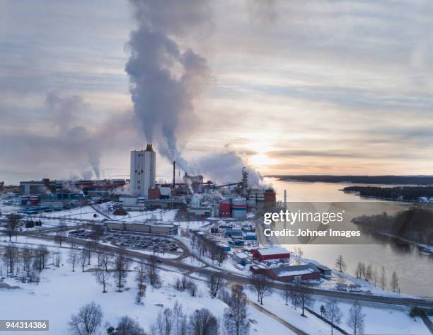 factory buildings at river - sweden snow stock pictures, royalty-free photos & images