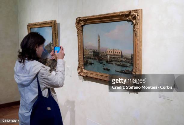 Visitor observes the painting 'The molo from the Bacino di San Marco, Venice' by 18th century Venetian master Giovanni Antonio Canal, known as...