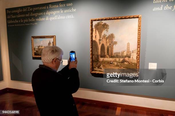 Visitors observes the painting 'The Basilica of Maxentius, Santa Francesca Romana and the Colosseum, Rome' by 18th century Venetian master Giovanni...