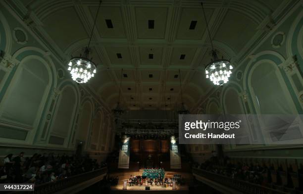 In this handout photo provided by Press Eye, musicians and a choir perform at a ceremony held this evening in the historic setting of the Ulster Hall...