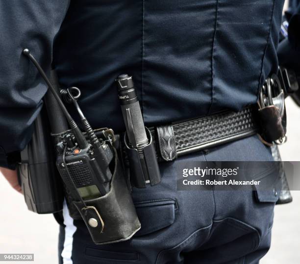 Police officer's duty belt hold his Motorola radio, handcuffs, service revolver and Turbo brand flashlight in Santa Fe, New Mexico.