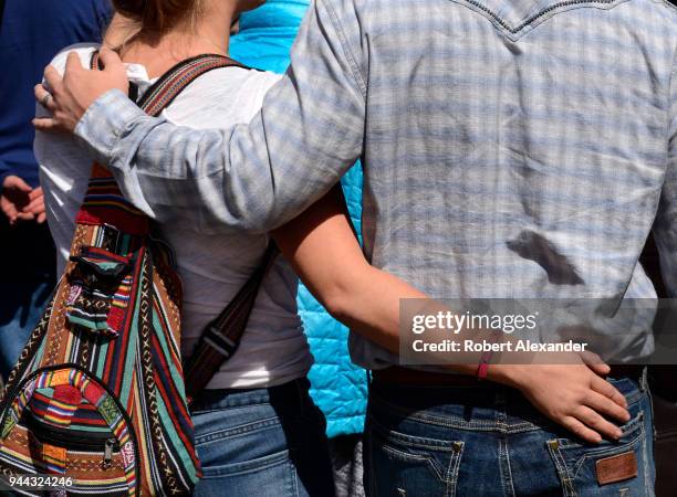 Young couple walk with arms around each other in Santa Fe, New Mexico.