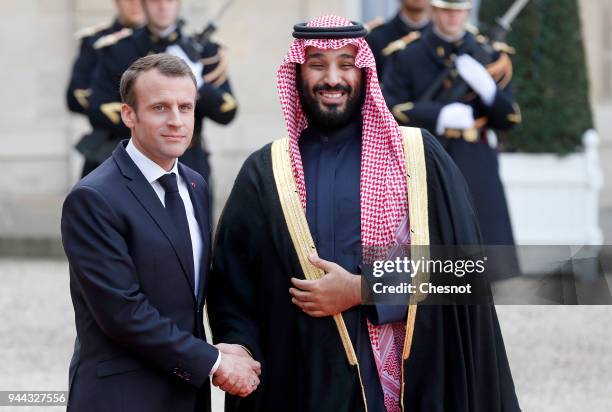 French President Emmanuel Macron welcomes Saudi Arabia's Crown Prince Mohammed bin Salman prior to their meeting at the Elysee Presidential Palace on...