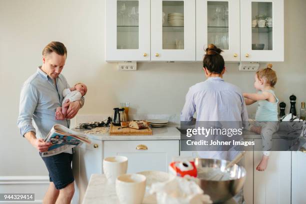 family in kitchen - kid mess child stock-fotos und bilder