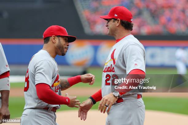 Tommy Pham of the St. Louis Cardinals hugs Manager Mike Matheny of the St. Louis Cardinals during player introductions prior to the the game against...