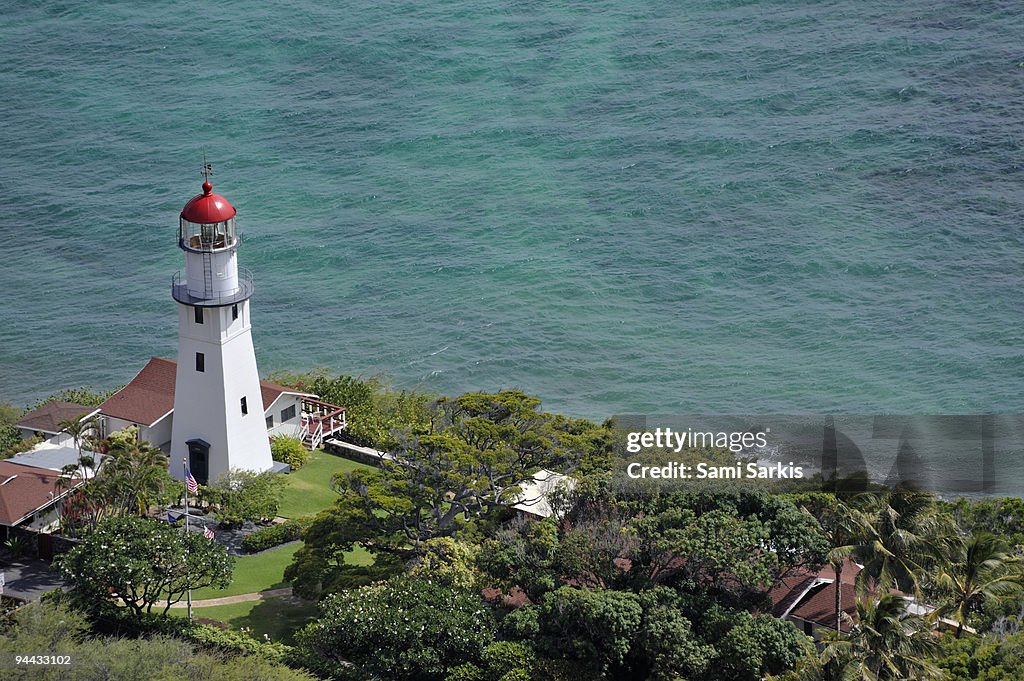 Lighthouse in garden on Pacific Ocean