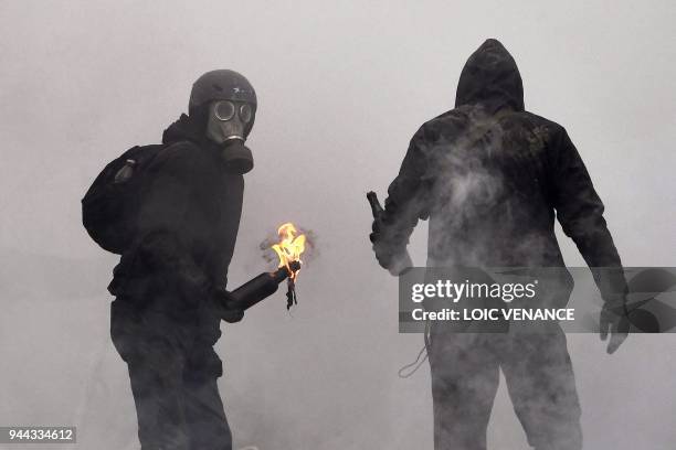 Protester prepares to throw a Molotov cocktail at riot forces as clashes erupt during a police operation to raze the decade-old camp known as ZAD at...