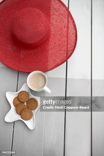 sun hat, tea and biscuits - heidi coppock beard stock pictures, royalty-free photos & images