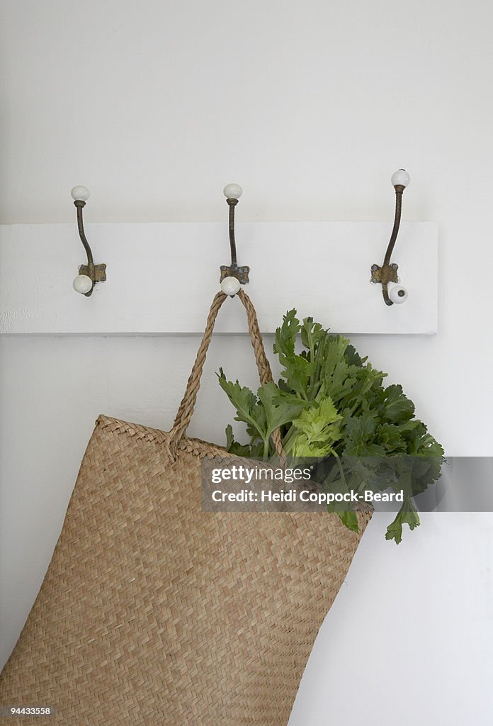 basket hanging on hook with vegtables in