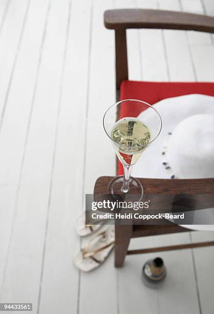 glass of bubbles with hat and sandals - heidi coppock beard stock pictures, royalty-free photos & images