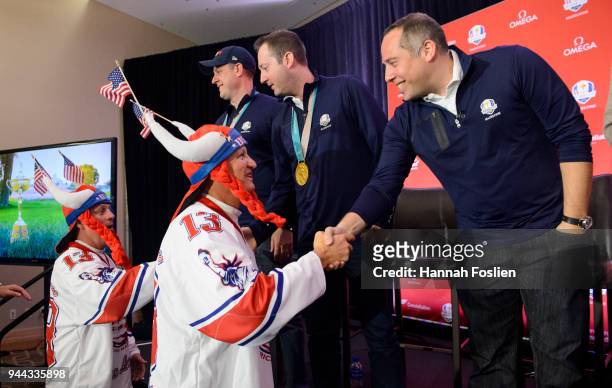 Gold medalist John Shuster, Tyler George and head coach Phill Drobnick of the United States Men's Curling Team shake hands with fans at the PGA of...