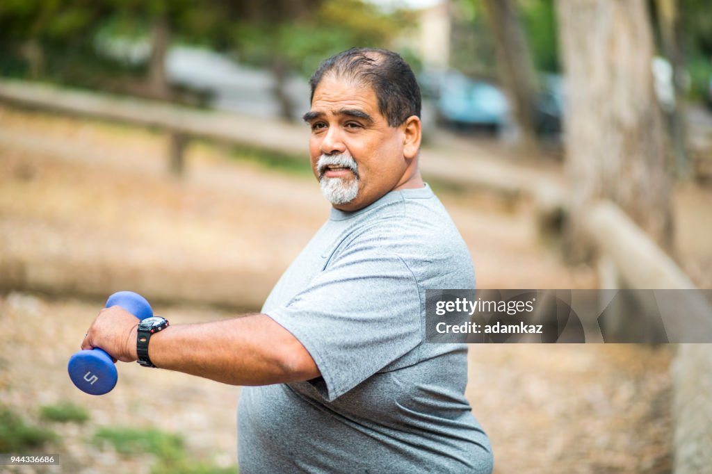 Senior Mexican Man Working Out Lifting Weights