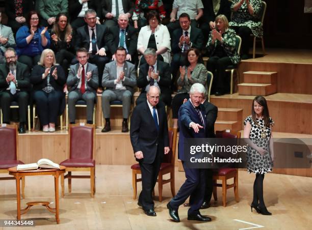 In this handout photo provided by Press Eye, former U.S. President Bill Clinton and and Senator George J. Mitchell attend a ceremony held in the...