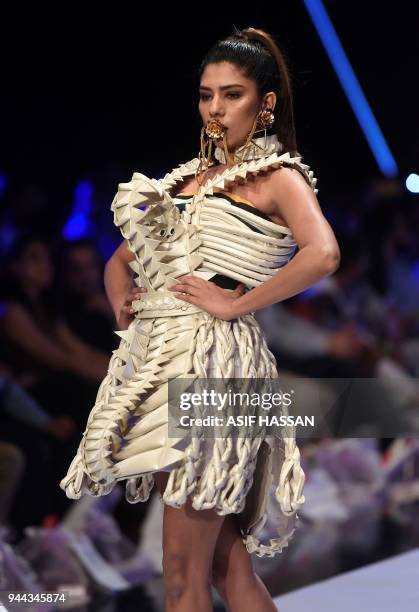 Model presents a creation by Pakistani designer Hassan Riaz on the first day of the Fashion Pakistan Week in Karachi on April 10, 2018. / AFP PHOTO /...