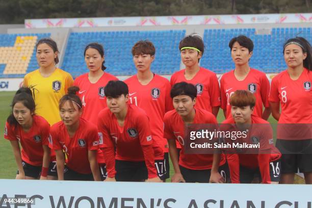 Head coach of Japan, Asako Takemoto discusses final remarks with a colleague prior to the AFC during the AFC Women's Asian Cup Group B match between...