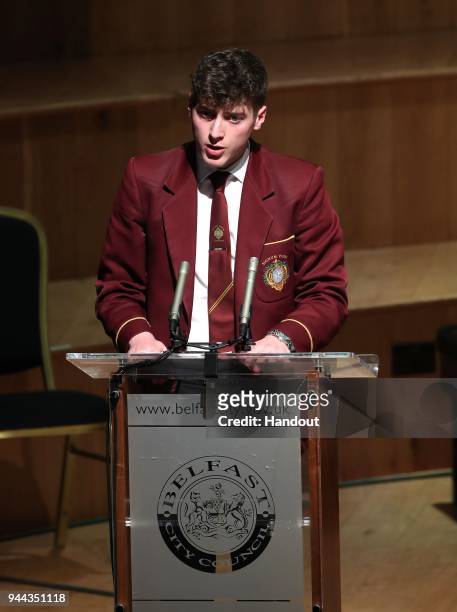 In this handout photo provided by Press Eye, a young man speaks as a ceremony is held in the historic setting of the Ulster Hall to confer the...