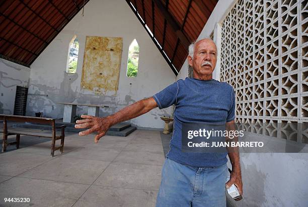Julian Diaz a survivor of the Los Corales area, in the coastal region La Guaira, state of Vargas, 50 km from Caracas, stands inside an empty church...