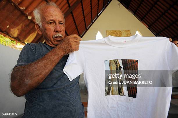 Julian Diaz a survivor of the Los Corales area, in the coastal region La Guaira, state of Vargas, 50 km from Caracas, shows a T-shirt inside an empty...