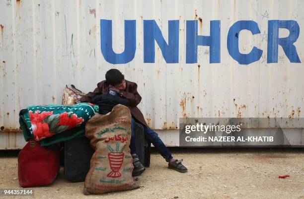 Syrian boy sits at a camp for displaced Syrians after buses carrying Jaish al-Islam fighters and their families from their former rebel bastion of...