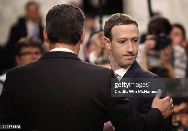 Facebook co-founder, Chairman and CEO Mark Zuckerberg speaks with a colleague as he arrives to testify before a combined Senate Judiciary and...
