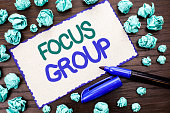 Writing note showing  Focus Group. Business photo showcasing Interactive Concentrating Planning Conference Survey Focused written on Cardboard Piece on the wooden background Marker next to it.