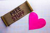 Handwriting text Free Stuff. Concept meaning Complementary Free of Cost Chargeless Gratis Costless Unpaid written on Cardboard Piece on the check background Heart next to it.