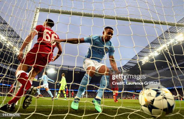 Gabriel Jesus of Manchester City collects the ball out of the net after he scores his sides first goal as Trent Alexander-Arnold of Liverpool reacts...