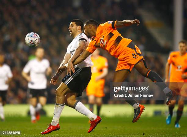 Aleksandar Mitrovic of Fulham is challenged by Liam Moore of Reading during the Sky Bet Championship match between Fulham and Reading at Craven...