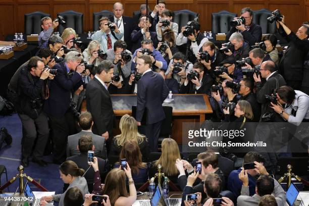 Facebook co-founder, Chairman and CEO Mark Zuckerberg speaks with a colleague as he arrives to testify before a combined Senate Judiciary and...