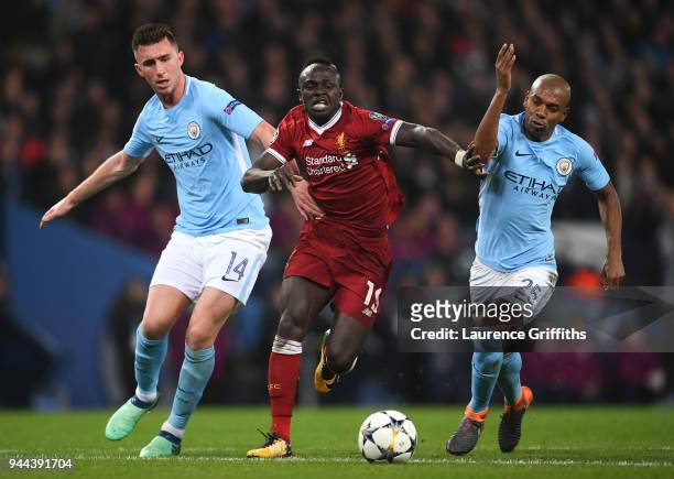 Aymeric Laporte of Manchester City battles for posession with Sadio Mane of Liverpool and Fernandinho of Manchester City during the UEFA Champions...