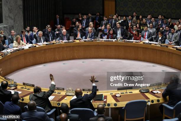 Members of the U.N. Security Council vote on a U.S. Draft resolution to create a new inquiry to find blame for the chemical weapons attack last week...