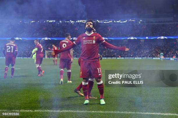 Liverpool's Egyptian midfielder Mohamed Salah celebrates scoring his team's first goal during the UEFA Champions League second leg quarter-final...