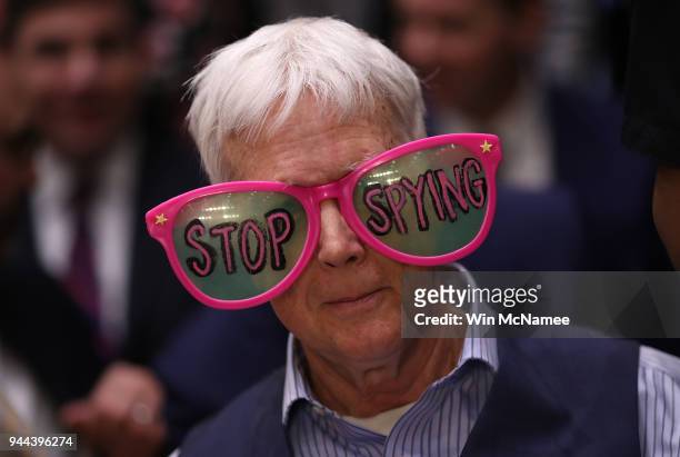 Protesters attend the hearing where Facebook co-founder, Chairman and CEO Mark Zuckerberg testified before a combined Senate Judiciary and Commerce...